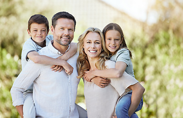 Image showing Their happiness means a lot to us. a couple spending time outdoors with their two children.