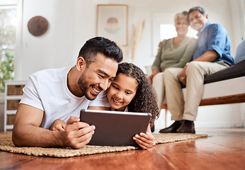 Image showing Introducing her to the digital world. a young father and daughter using a digital tablet together at home.