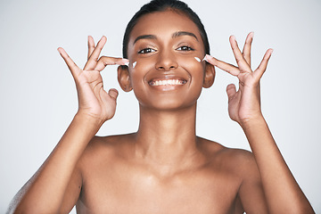 Image showing Theres nothing more beautiful than moisturised skin. a beautiful woman applying moisturiser to her face.