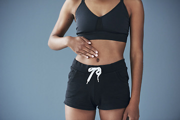 Image showing Good health, you can feel it in your gut. Closeup shot of a sporty young woman posing with her hand on her stomach.