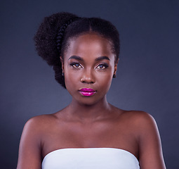 Image showing Beauty is self-confidence applied directly to the face. Studio portrait of a beautiful young woman posing against a black background.