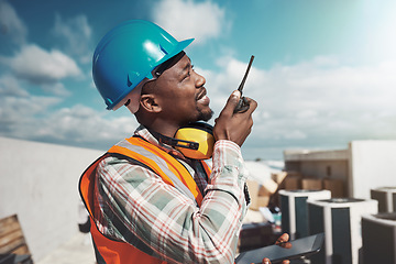 Image showing Nothing keeps a project on task like consistent communication. a young man using a walkie talkie while working at a construction site.