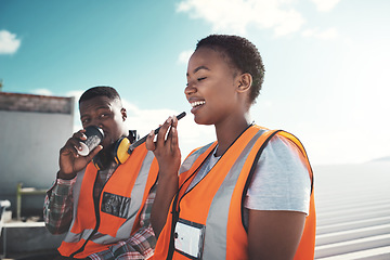 Image showing Who needs a water cooler to chill out. a young woman using a smartphone on a coffee break at a construction site.