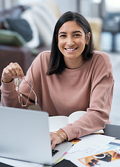 Image showing Bringing you the best designs straight from my home. a confident young woman using a laptop while working from home.