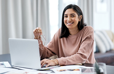 Image showing Who doesnt love the flexibility of working from home. a confident young woman using a laptop while working from home.