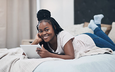 Image showing Browsing in bed all day long. a young woman using a digital tablet while relaxing on her bed at home.