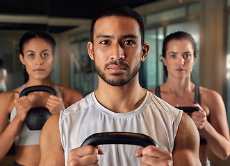 Image showing Were here for fitness. Cropped portrait of three young athletes working out with kettle bells in the gym.