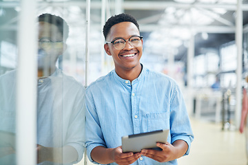 Image showing To stay organised you’ve got too keep it smart. a young businessman using a digital tablet in a modern office.