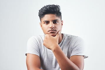 Image showing Dont let it change you. Studio shot of a young man sitting against a white background.