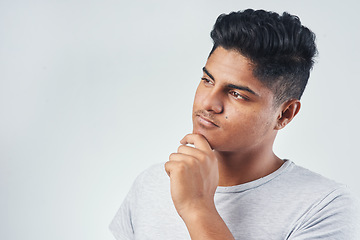 Image showing I cant stop thinking about it. Studio shot of a young man posing against a white background.