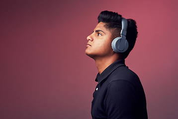 Image showing Let music take control. Studio shot of a handsome young man wearing headphones.