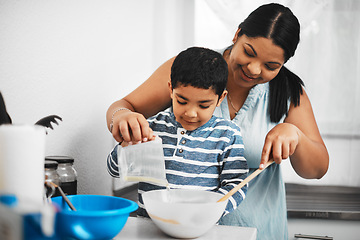 Image showing Hands-on cooking activities help children develop confidence and skill. a mother and her little son baking together at home.