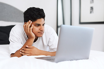 Image showing Its a binge-watching kinda day. an young man using his laptop while lying on his bed.