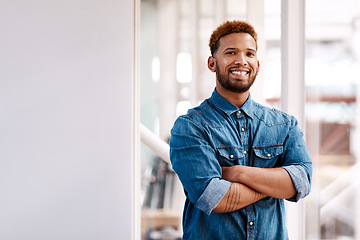 Image showing Confident in my creativity. Cropped portrait of a handsome young male designer standing with his arms folded in the office.