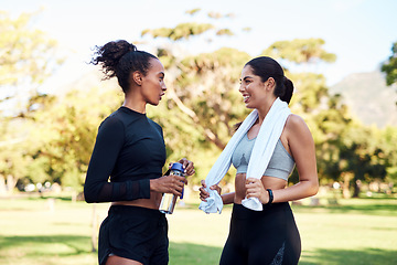 Image showing That felt good. two attractive young women smiling at each other after their run in the park during the day.