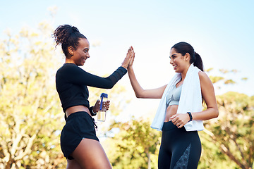 Image showing Well done. two attractive young women giving each other a high-five after their run in the park.