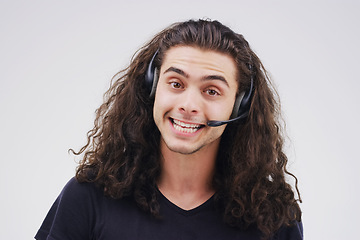 Image showing Im glad I could be of assistance. Studio portrait of a handsome young male customer service representative wearing a headset against a grey background.