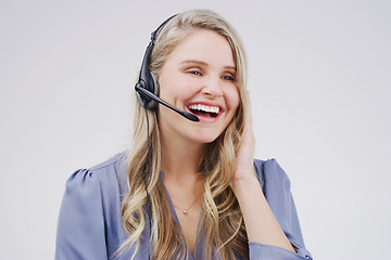 Image showing She handles every call seamlessly and effortlessly. Studio shot of an attractive young female customer service representative wearing a headset against a grey background.