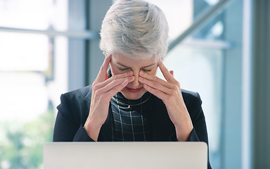 Image showing The pressure is mounting. a mature businesswoman looking stressed out while working in an office.