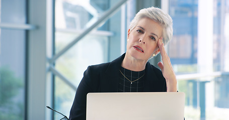 Image showing Dealing with the downs of business. Portrait of a mature businesswoman looking stressed out while working in an office.