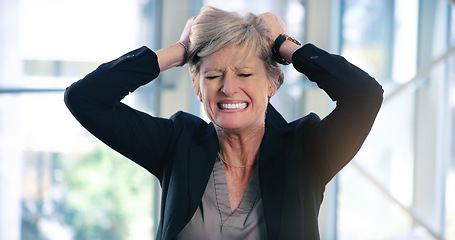 Image showing Why wont anything go my way. a mature businesswoman looking stressed out in an office.