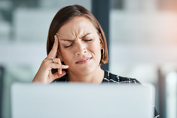 Image showing I cant deal with this pain. a young businesswoman suffering with a headache while working in an office.