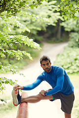 Image showing Stretch for a better workout. a sporty man starting his exercise routine with stretching exercises.