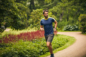 Image showing Nothing can stop you if you dont want to be stopped. a sporty middle-aged man out running in a park.