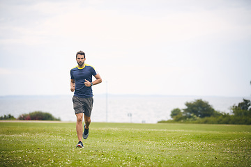 Image showing Your health will thank you later. a sporty middle-aged man out running in a park.