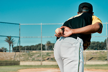 Image showing This will settle the score. Rearview shot of a baseball player holding the ball behind his back.