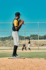 Image showing A really good pitcher is tough to beat. a young baseball player getting ready to pitch the ball during a game outdoors.