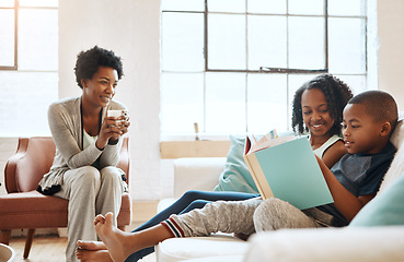 Image showing I love watching them read together. a little brother and sister reading a book while their mother watches at home.