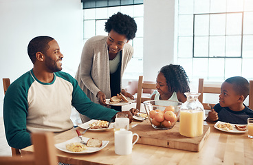 Image showing When it comes to our family, we make breakfast fun. a family having breakfast together at home.