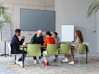 Image showing A diverse group of business professionals gathered at a modern office for a productive and inclusive meeting