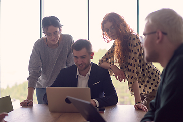 Image showing A diverse group of business professionals gathered at a modern office for a productive and inclusive meeting