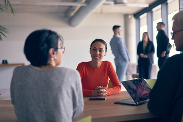 Image showing A diverse group of business professionals gathered at a modern office for a productive and inclusive meeting