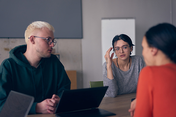 Image showing A diverse group of business professionals gathered at a modern office for a productive and inclusive meeting