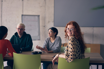 Image showing A diverse group of business professionals gathered at a modern office for a productive and inclusive meeting