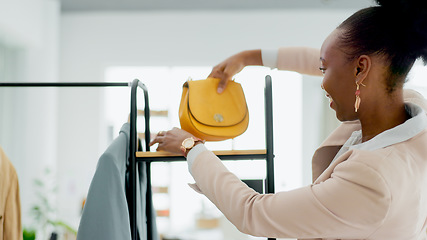 Image showing Fashion, bag and a black woman designer in a retail store as a small business owner or startup entrepreneur. Smile, accessories and a happy young employee in a shop at the mall for boutique sales