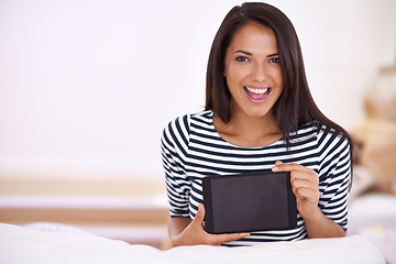 Image showing Im so excited about my new app. Portrait of an attractive young woman holding up her digital tablet.