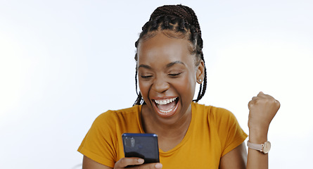Image showing Phone, black woman and happy fist for success, celebration or achievement and winner for giveaway in studio on white background. Excited, prize and person with smartphone celebrate winning lottery