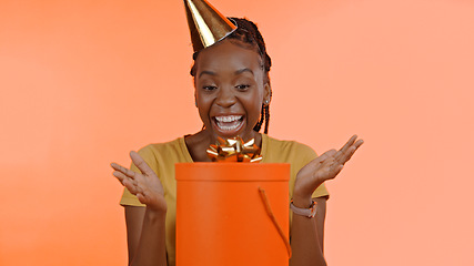 Image showing Birthday, surprise and black woman with present, box or gift in studio background or celebration. Wow, congratulations and excited winner of giveaway, package or product on offer for party and event