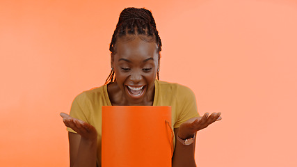 Image showing Unboxing, present and black woman with birthday, surprise and box in studio background or celebration. Wow, congratulations and excited winner of giveaway, package and open box with happiness