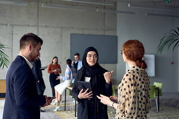 Image showing A group of young business entrepreneurs engages in a lively discussion within the office, exemplifying the spirit of teamwork, innovation, and ambition in pursuit of success.