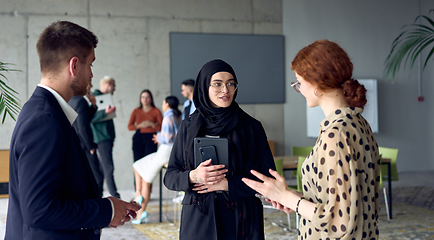 Image showing A group of young business entrepreneurs engages in a lively discussion within the office, exemplifying the spirit of teamwork, innovation, and ambition in pursuit of success.