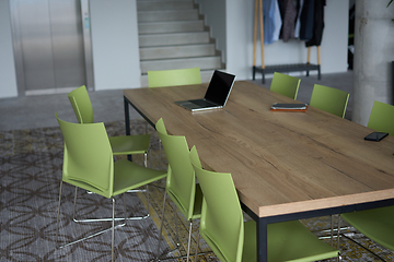 Image showing Interior of a business facility showcasing a well equipped office with a laptop and smartphones, reflecting a modern and efficient work environment.