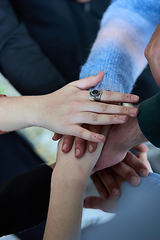 Image showing A top view photo of group of businessmen holding hands together to symbolize unity and strength