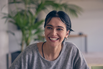 Image showing In a modern office, a young smile businesswoman with glasses confidently explains and presents various business ideas to her colleagues, showcasing her professionalism and expertise.