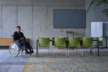 Image showing Businessman in a wheelchair in a modern office lonely after a busy day