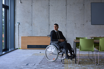 Image showing Businessman in a wheelchair in a modern office lonely after a busy day